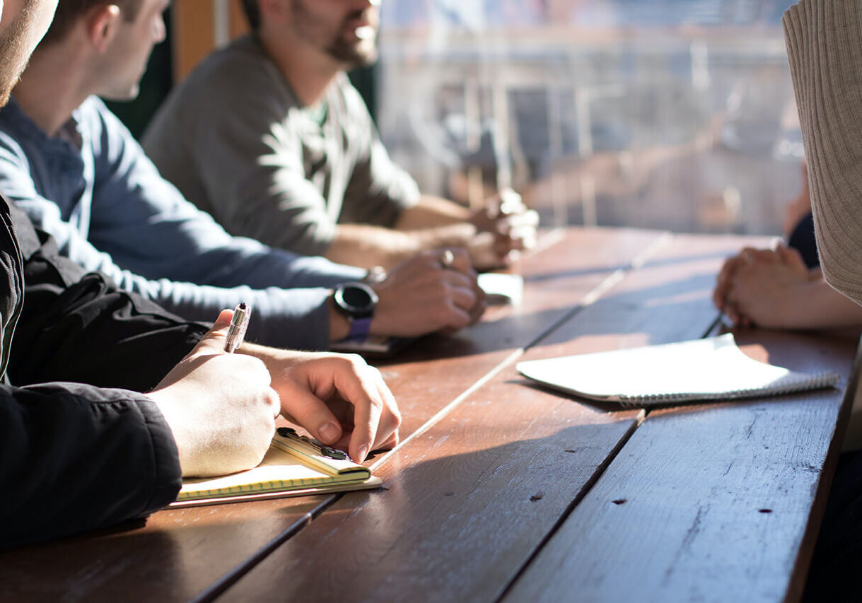 people sitting in a group at a conference table